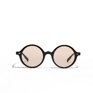 Vintage round oversized sunglasses with black frame and light brown lenses for fashion wear