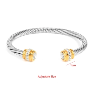 Detail of twisted cable cuff bracelet in silver and gold with sparkling crystal inlay