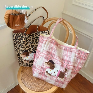 Detail showing reversible tote bags with leopard print and dachshund plush patch decor