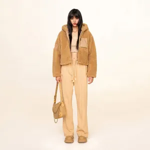 Women's brown faux shearling hooded jacket and beige drawstring straight leg track pants