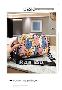 Detail of colorful cartoon rabbit print on crossbody bag with wide logo strap
