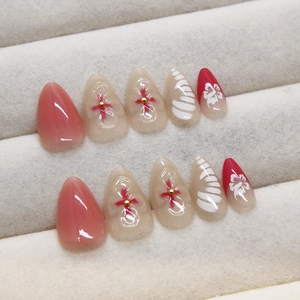 Pink and white 3D floral press-on nails with glitter finish in a velvet box