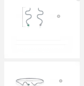 Detail of s925 silver snake jewelry set with green gemstone eyes and micro-pave diamonds