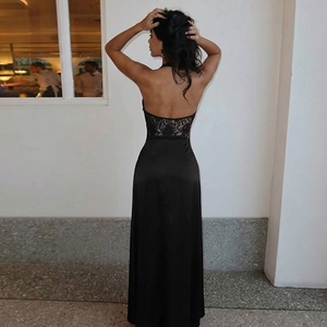 Detailed back view of backless black dress featuring elegant lace patchwork and satin finish