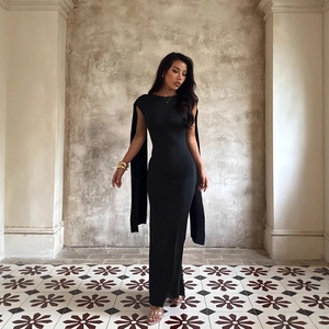 Elegant black backless slim fit evening gown with cape detail and metallic accessories