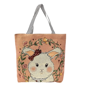 Pink canvas tote bag featuring a cute white rabbit and striped handles on white background