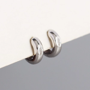 Macro detail of S925 silver hoop earrings with marquise zircon stone inlay