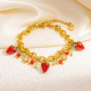 Detail of 18k gold plated stainless steel bracelet with red strawberry and green beads