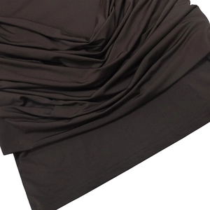 Detailed close-up of dark brown ruched fabric with premium double-stitch hemline craftsmanship