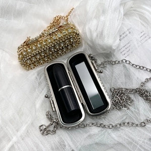 Detail of mini lipstick bags in gold and silver rhinestone with interior mirrors