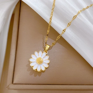 Elegant rotating sunflower necklace with gold chain and crystals on a luxury leather box