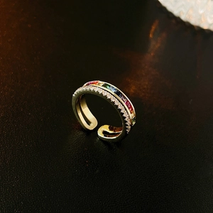 Macro detail of gold plated open ring with rainbow cubic zirconia and micro-set stones