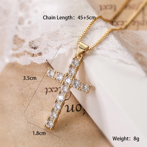 Detail showing gold cross pendant dimensions 3.5cm by 1.8cm with clear zircon stones