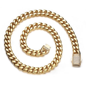 Macro detail of gold Cuban link chain with a sparkling rhinestone encrusted box clasp