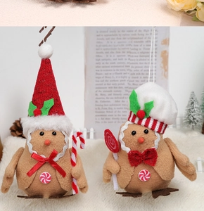 Close-up of gingerbread bird plush ornaments with Christmas hats and candy accessories