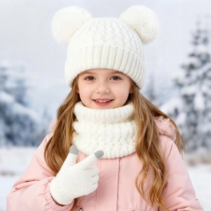 Detail of white knit hat with dual pom-poms, matching scarf, and touchscreen gloves
