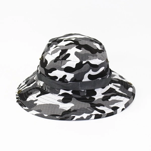 Detail of camouflage boonie hat with wide brim and metal side ventilation eyelets