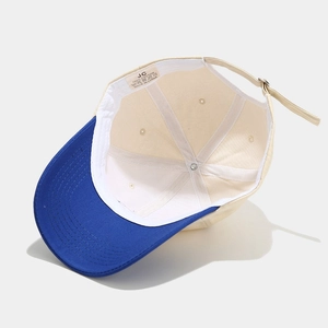 Detail view of cotton lining, stitching, and adjustable metal buckle on baseball cap