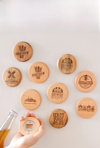 Detail of round wooden magnetic beer opener with vintage laser-engraved designs