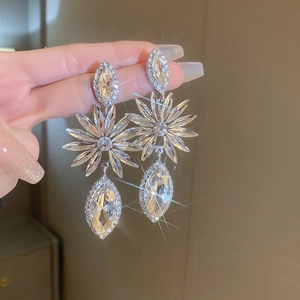 Close-up of sparkling floral drop earrings with marquise crystals and silver finish