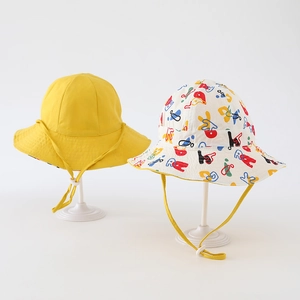 Detail view of cotton kids bucket hat showing adjustable chin strap and graffiti print