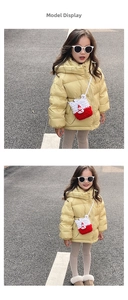 Close-up of a handmade red and white knitted snowman crossbody bag for kids' winter outfits