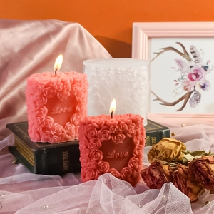 Detail of heart-shaped rose relief scented candles with Love embossed lettering