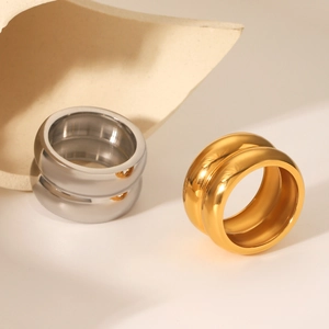 Minimalist double layer 18K gold and silver stainless steel rings on a beige background