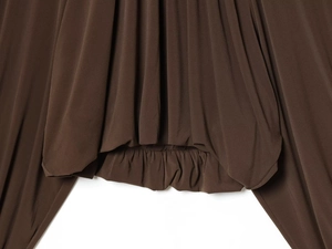 Detail of dark brown pleated hem with elastic band showing smooth fabric texture