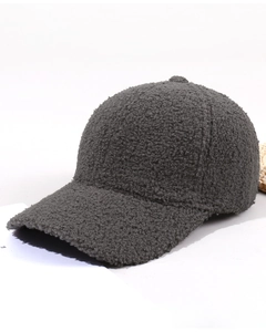 Detailed texture of dark grey teddy fleece fabric on a winter baseball cap side view