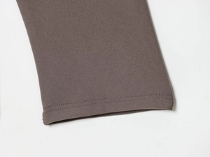 Detailed close-up of dark coffee V-neck dress featuring precision double-needle stitching