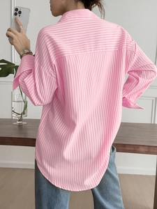 Detail view of the back design on this pink and white striped long-sleeved shirt for women