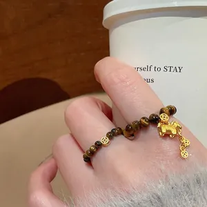 Tiger eye stone stretch ring with golden pig charm and copper coin in retro Chinese style