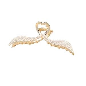 Golden metal angel wing hair claw clip with white pearls and heart detail on white background