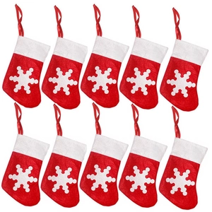 Set of 10 red felt Christmas stocking cutlery holders with white snowflake patterns