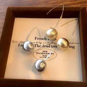 Minimalist matte metal ball drop earrings in gold and silver finish with long hooks