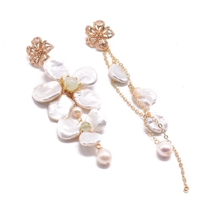 Asymmetric gold flower earrings with Baroque pearls and jade tassels on white background