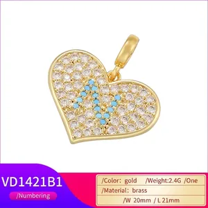 Gold plated brass heart pendant with shimmering zircon and blue letter N charm