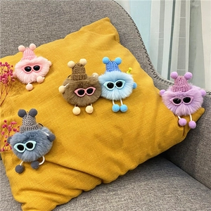 Cute fuzzy soot sprite keychains with knit hats and sunglasses in five vibrant colors