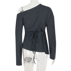 Detail of off-shoulder long-sleeve knit top with ribbed texture and waist tie design