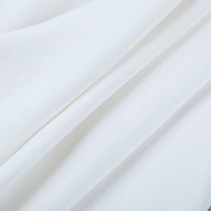 Close-up of premium white woven fabric texture showing smooth fibers and soft shadow