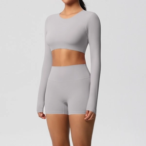 Detail of high-waist fitness shorts and long-sleeved crop top set in mauve brush fabric