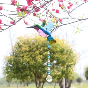 Detail of hummingbird crystal suncatcher with colorful wings and faceted glass pendant