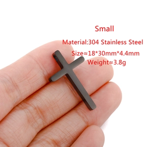 Small black stainless steel cross pendant size specifications with hand holding product