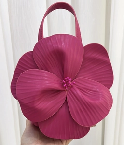 Detail of creative 3D floral tote bag with textured petals and beaded center