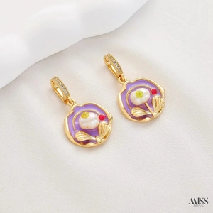 Detail of floral enamel pendant with natural pearl and purple flower design