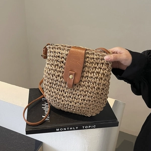 Handcrafted khaki paper straw saddle bag with brown PU leather strap and flap closure