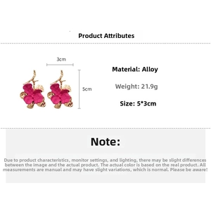 Macro shot of rose red flower earrings showing size 5cm by 3cm and alloy material