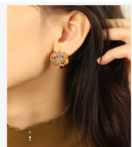 Detailed view of luxury heart-shaped gold earring set with colorful pavé rhinestones