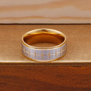 Detail of two-tone titanium ring with brushed silver finish and geometric cross carvings